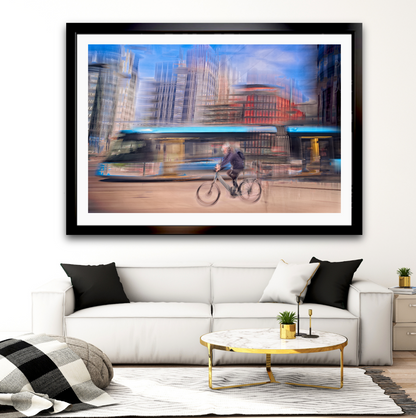 Downtown Deadline, a cyclist racing a tram through Oslo city streets — ICM photography cycling wall art print by Douglas Carr at Oslo Art Prints